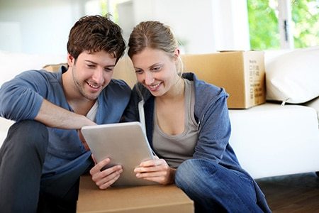 Couple looking at prices for house removals