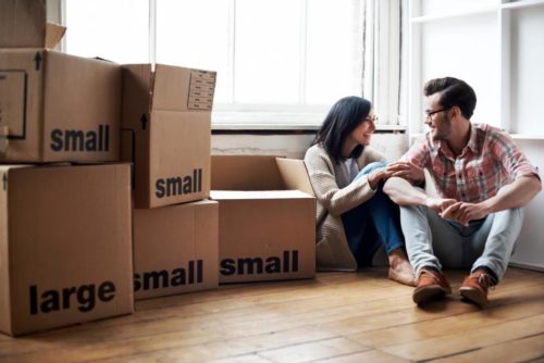 Young adults in their new home, benefiting from various types of moving services