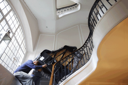 Moving a piano up a flight of stairs - piano removals